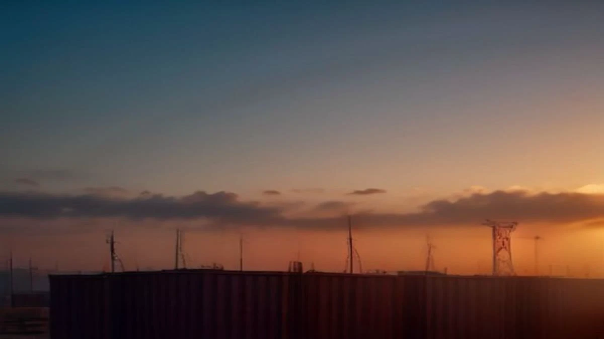 Illustration: shallow depth of field close-up of a shipping container yard at golden hour with cranes in the background, overcast diffused light